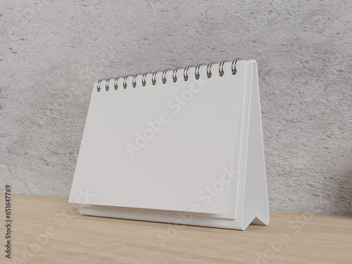 Blank Landscape Desk calendar on table, persepective view. for mockup design photo