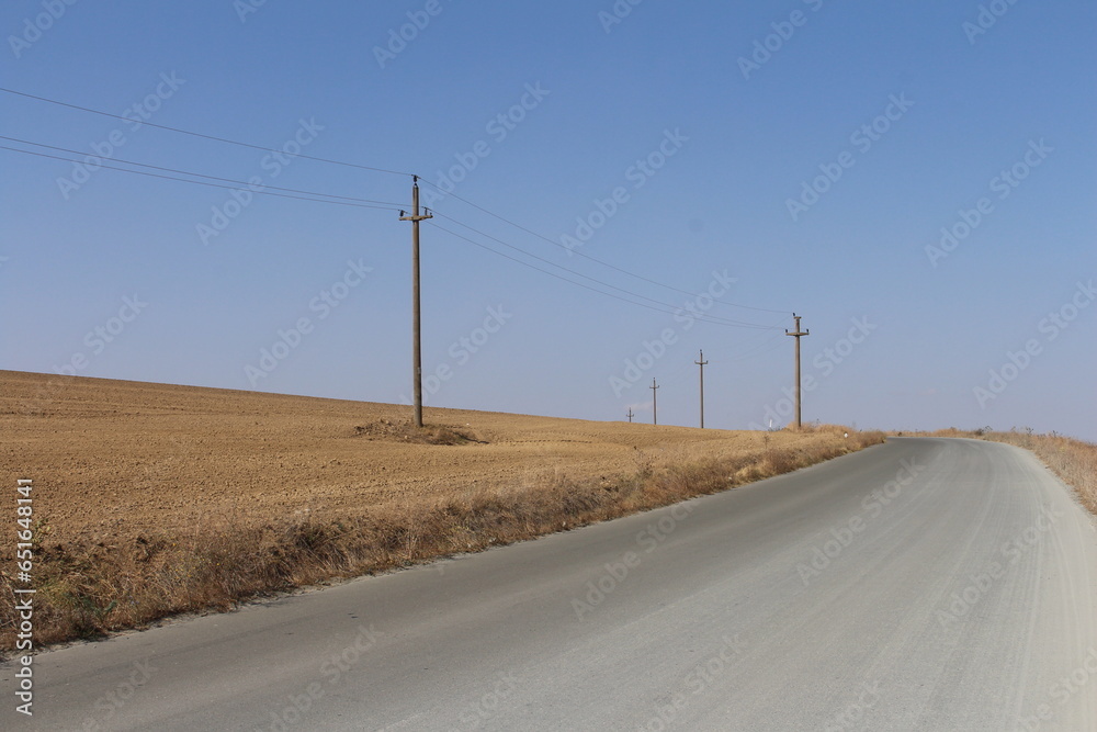 A road with power lines on the side