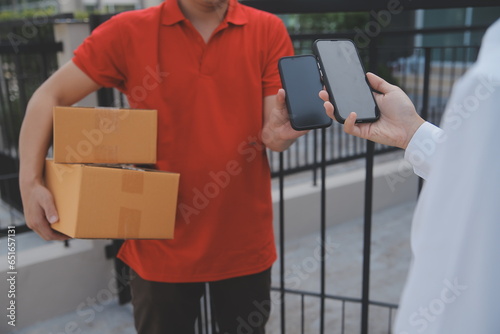 Asian Woman Receiving Product from delivery man at Home, Young Owner Woman Order Product from Smartphone Application, Woman with Online Business or SME Concept.