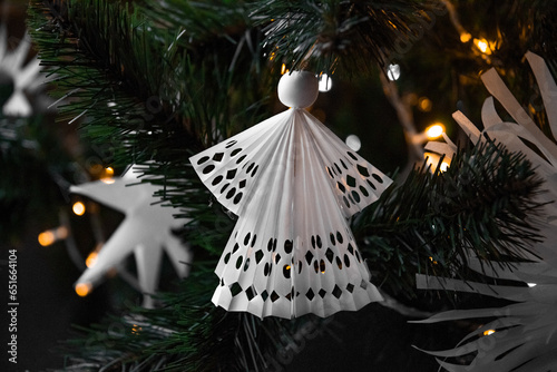 Origami decorations for the Christmas tree. Handmade, hobby Christmas tree toys. Paper crafts, handcrafts, homemade, handworks. Postcard, background for Christmas and new year. Angel and snowflake. photo