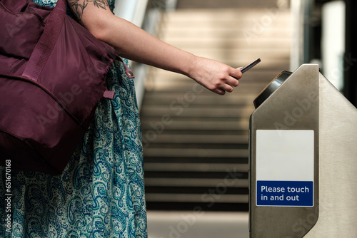 Unrecognizable woman holding card on card reader transport. photo