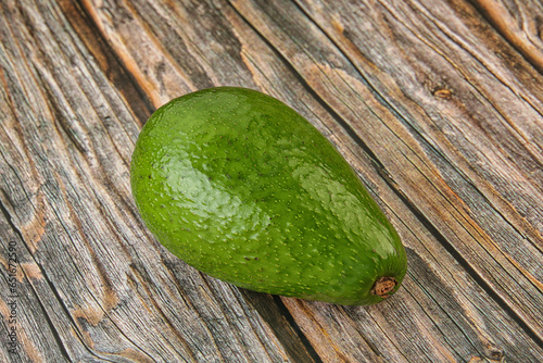 Ripe green avocado over background