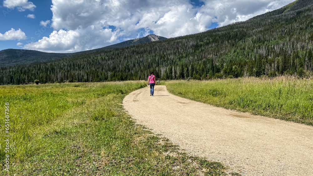Woman on walking path in Holzwarth Historic Site in Rocky Mountain National Park