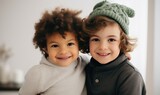Two kids in winter wreath smiling together. Family concept.