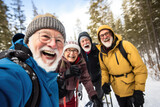 Senior hikers revel in the crisp winter air, experiencing the rewards of exploration and camaraderie on a snowy trail.