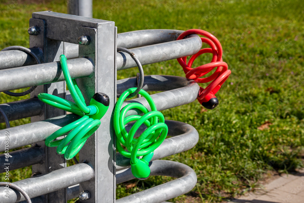 
bicycle dock with red on green chains on it