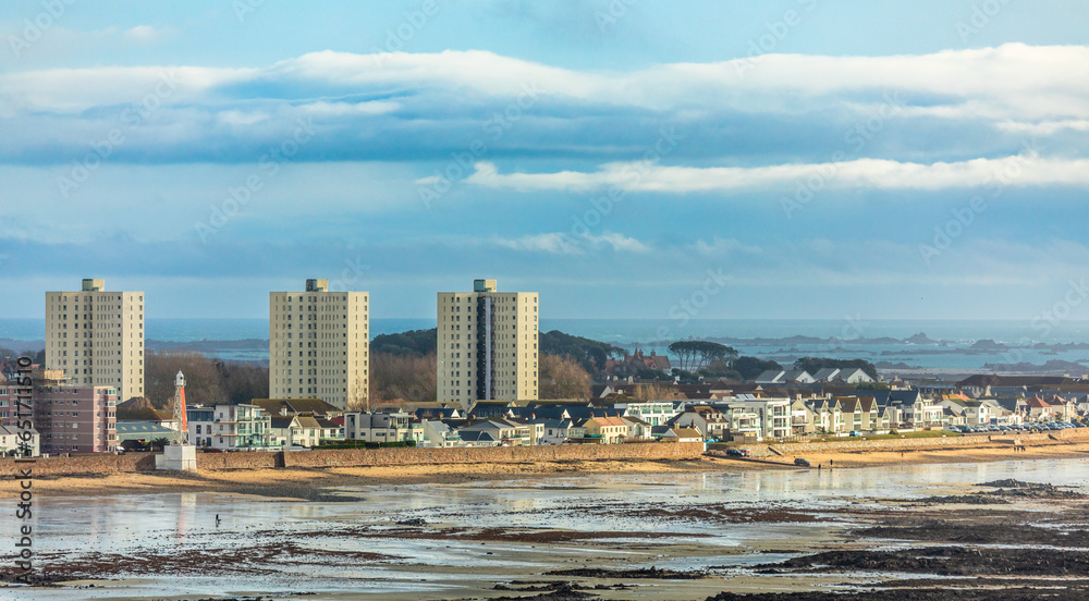 Saint Helier capital city panorama with buildings and residential houses on the La Manche seashore, in low tide, bailiwick of Jersey, Channel Islands, Great Britain