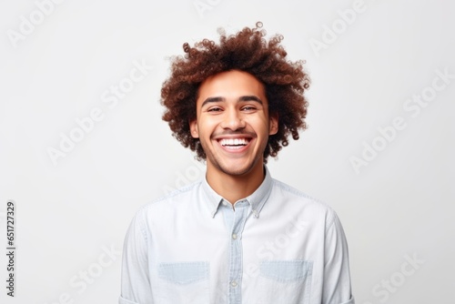Cheerful Curly Haired Guy: Positive Emotion Headshot on White © Philipp