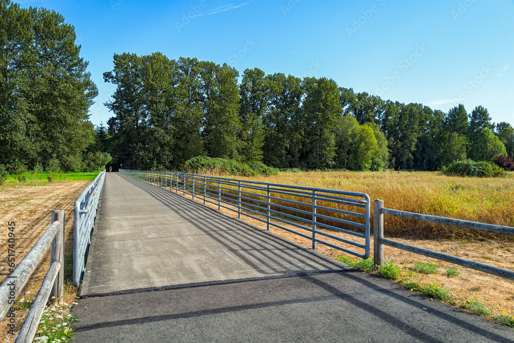 Bicyclists approach the fenced section of the trail at Marymoor Park in Redmond, Washington, USA