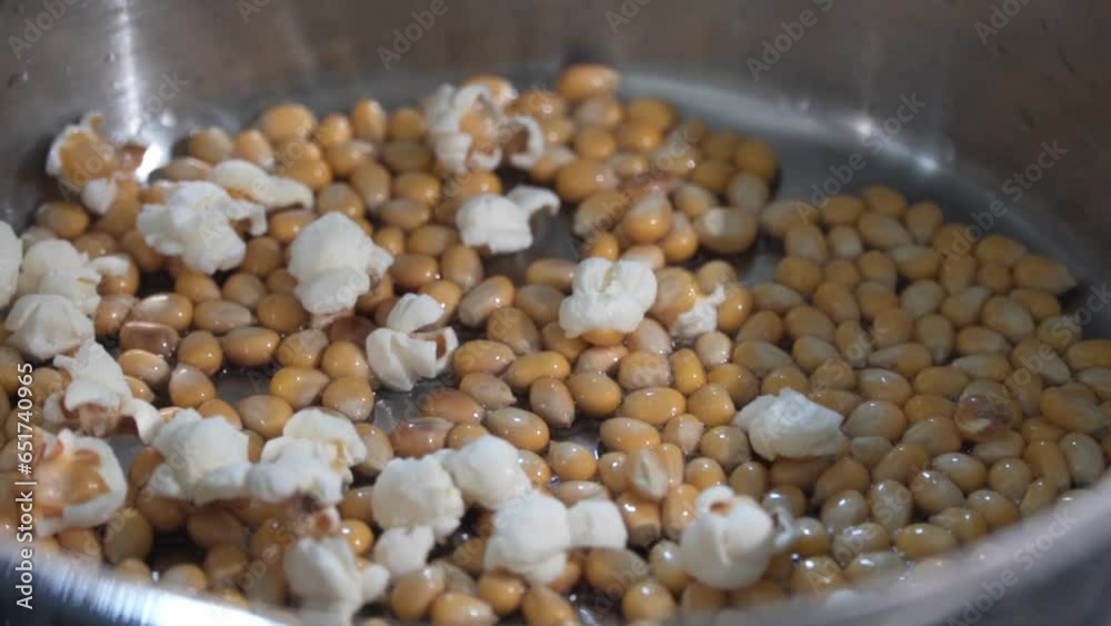 Freshly popped popcorn in a pot. Corn and oil in a pot. Summer food and snack footage. Freshly popped popcorn in a pot. Corn and oil in a pot. Summer food and snack footage.