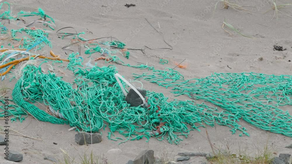 45441_A_green_fishing_net_scattered_on_the_shore.mov