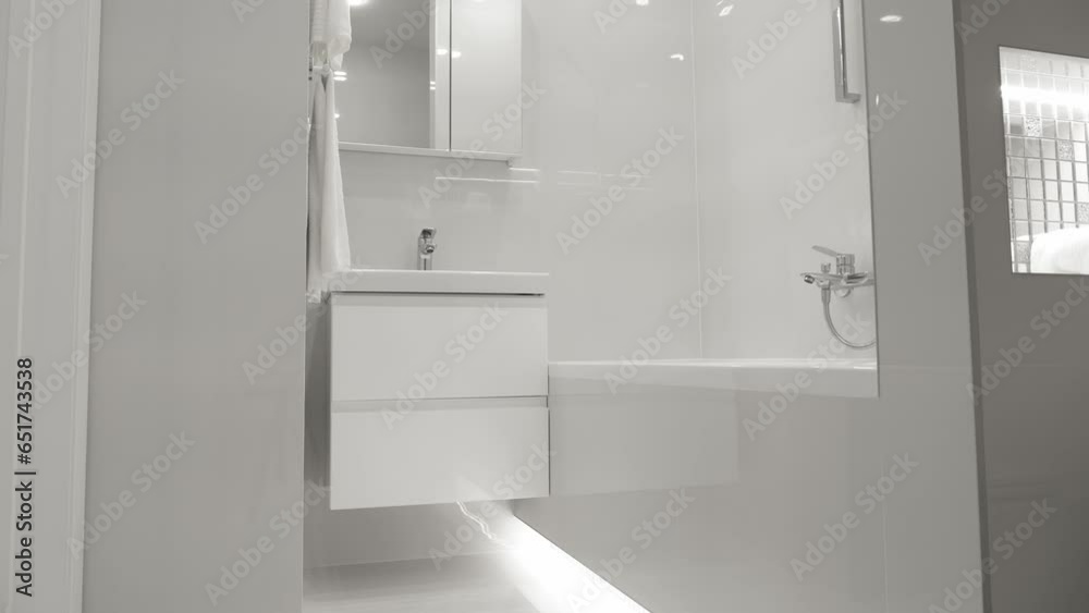 Contemporary interior of white monochrome bathroom. Minimalism Contemporary interior of white monochrome bathroom. Minimalism