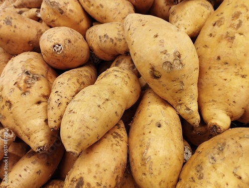 Close-up photo of a pile of Cilembu sweet potatoes or Ipomoea batatas, which are sold in a supermarket. When baked, this sweet potato tastes very sweet, useful for maintaining blood sugar levels.