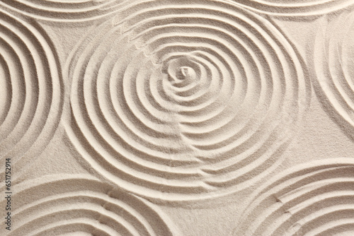 Beautiful spirals on sand, above view. Zen garden