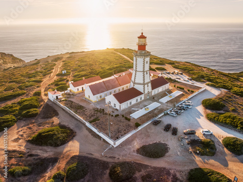 Aerial drone view of lighthouse on Cabo Espichel cape Espichel on Atlantic ocean at sunset. Sesimbra, Portugal