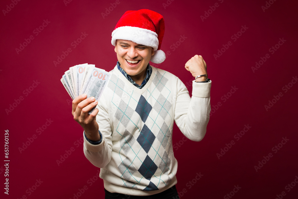 Happy latin man earning a lot of money during christmas Happy latin man earning a lot of money during christmas