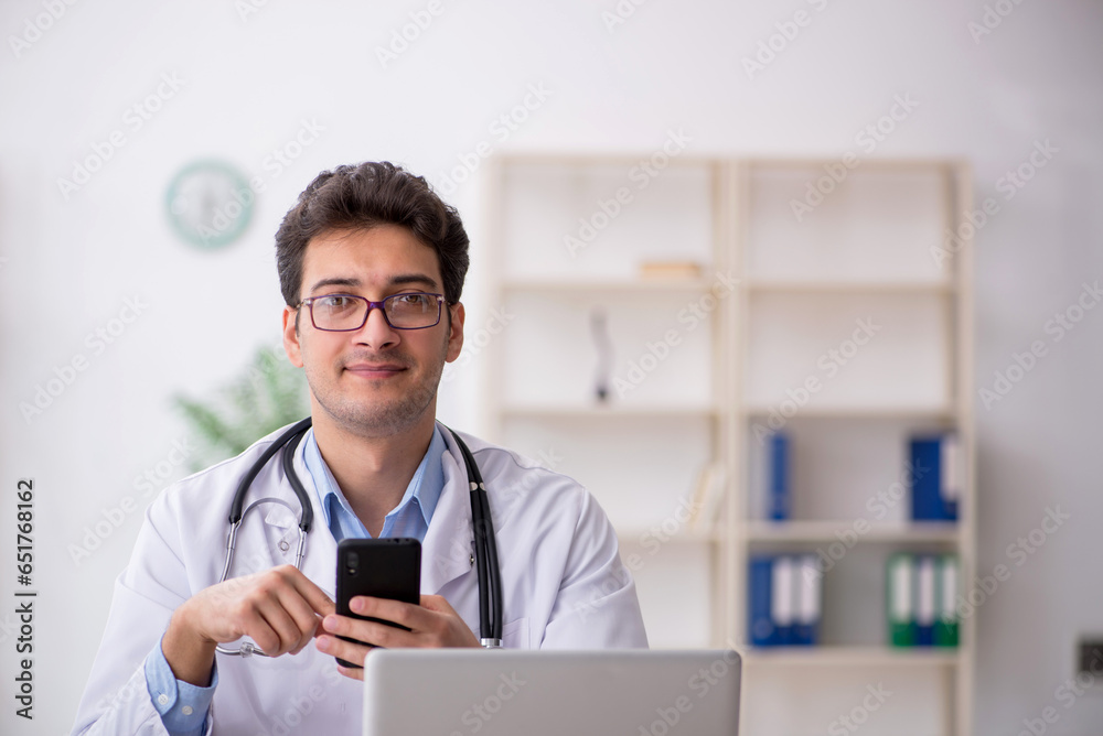 Young male doctor in telemedicine concept Young male doctor in telemedicine concept