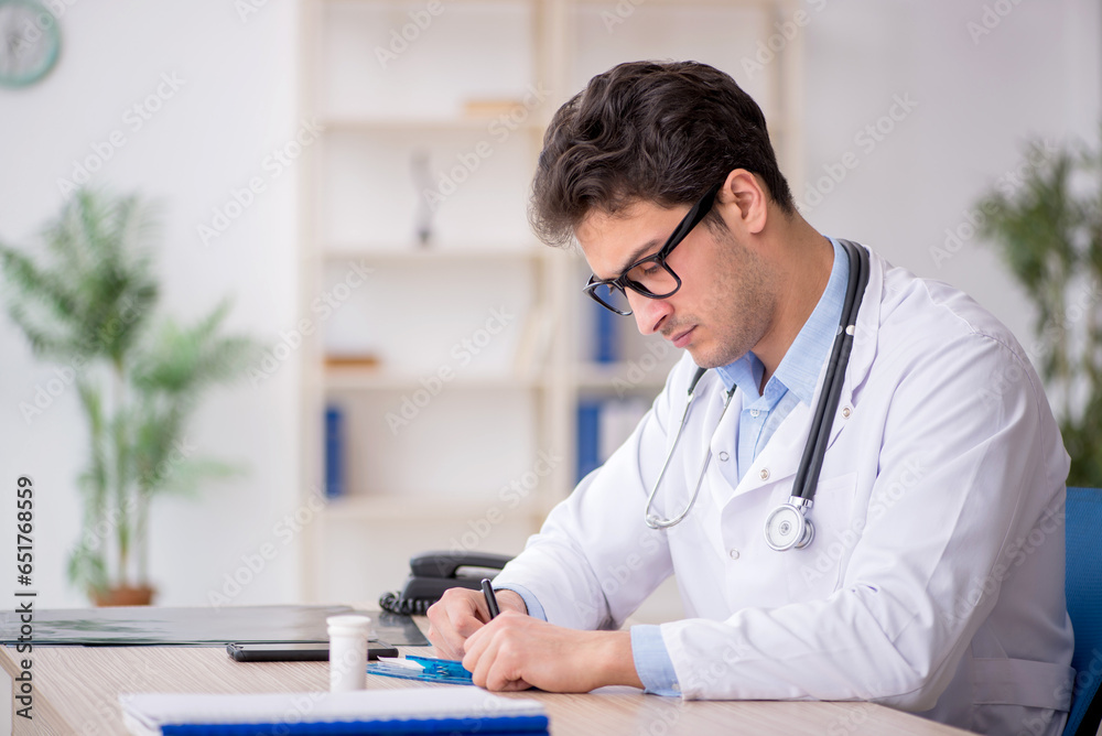 Young male doctor working in the clinic Young male doctor working in the clinic
