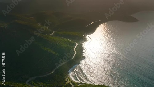 Aerial Tilt-Up Shot Of Beach Coastline By Winding Roads Against Cloudy Sky At Sunset - La Digue, Seychelles