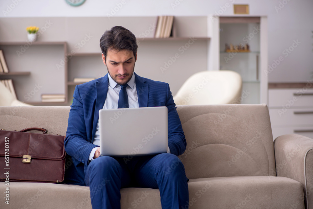 Young male employee working from home during pandemic Young male employee working from home during pandemic