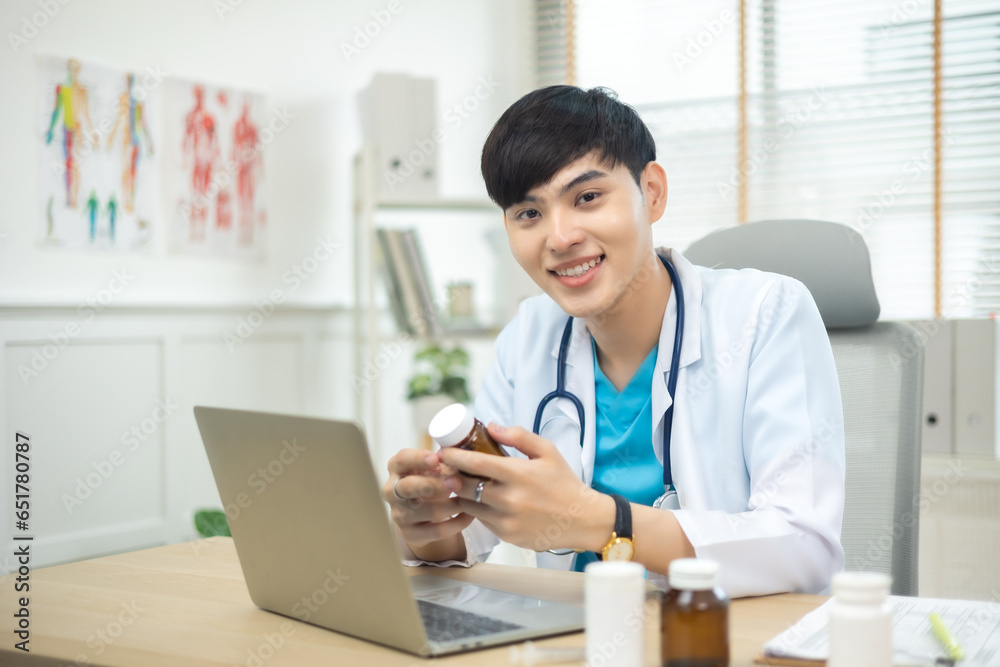 Young asian man wearing doctor uniform smiling confident at clinic,looking and smiling at camera... Young asian man wearing doctor uniform smiling confident at clinic,looking and smiling at camera...
