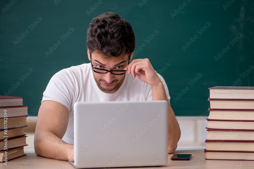 Young male student sitting in the classroom Young male student sitting in the classroom