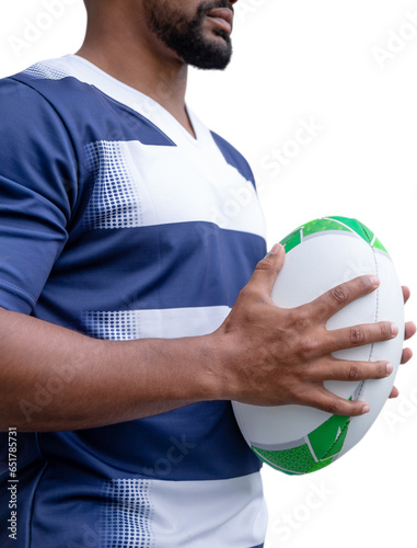 Digital png photo of happy biracial rugby player holding ball on transparent background
