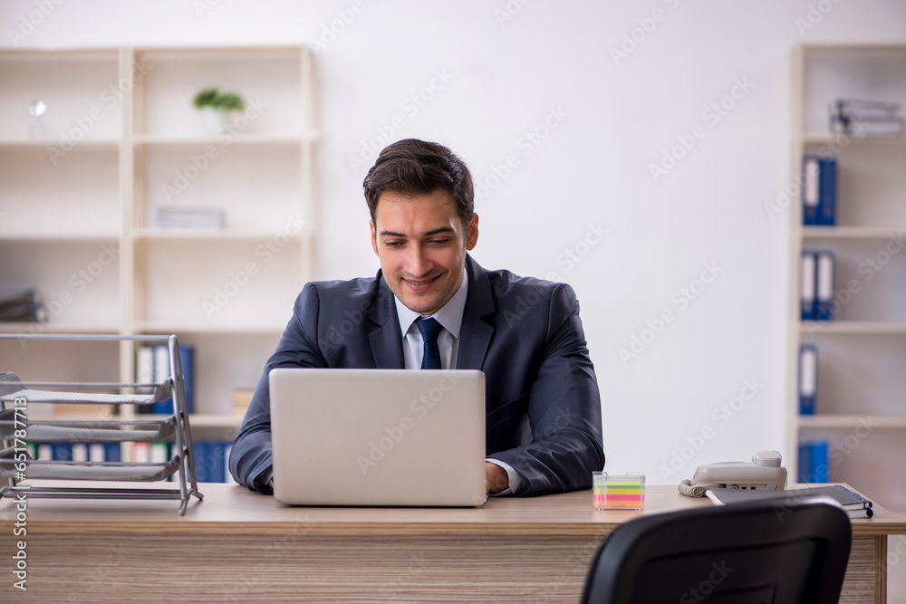 Young male employee working in the office Young male employee working in the office