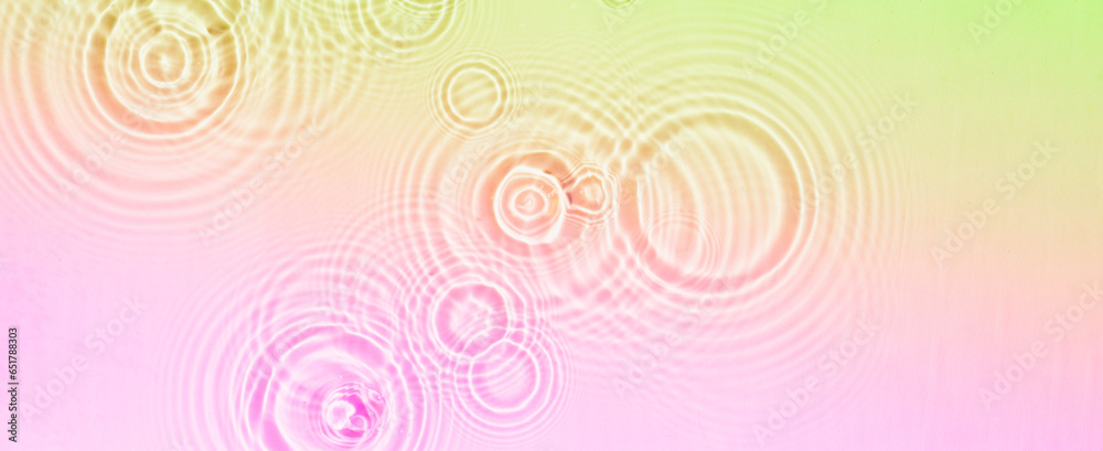 Circles and waves on water of coral rainbow color in sunlight Circles and waves on water of coral rainbow color in sunlight