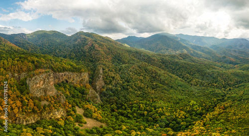 bee rocks near the Altubinal farm in the forested mountains of the Western Caucasus on a cloudy day in early autumn - aerial panorama