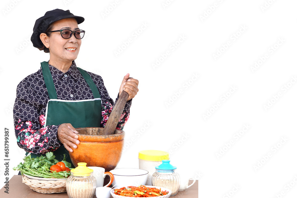 Happy Asian senior woman is cooking, hold mortar and pestle, prepare food ingredients, white background. Concept, Cooking for family. Thai kitchen lifestyle. Elderly activity. Happy Asian senior woman is cooking, hold mortar and pestle, prepare food ingredients, white background. Concept, Cooking for family. Thai kitchen lifestyle. Elderly activity.
