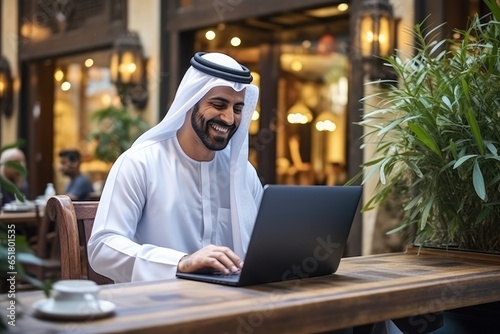 Middle Eastern Man at Laptop in Coffee Shop