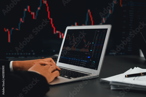Stock trading investor monitoring dynamic financial data graph for profitable trade. Businessman or broker with analytic thinking analyzing data for stock market exchange trading company. Trailblazing