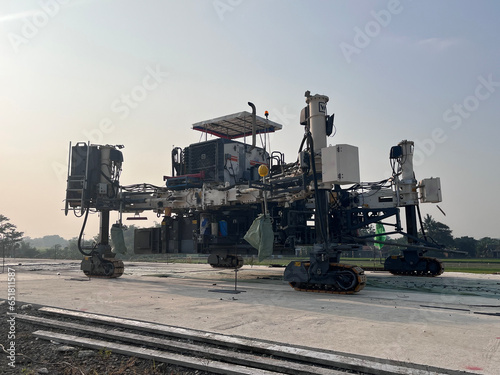 Slipform paver machine on road work at construction site. Highway concrete paving in the new quarter. Repairing concrete roads using new technology. machine