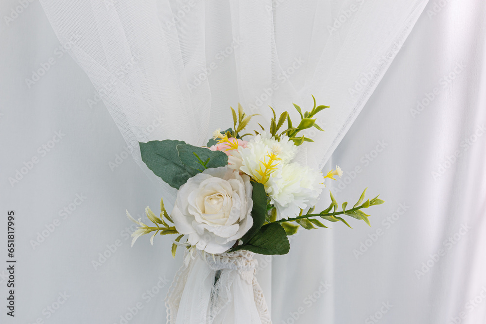 Plastic flowers on a white cloth background Plastic flowers on a white cloth background