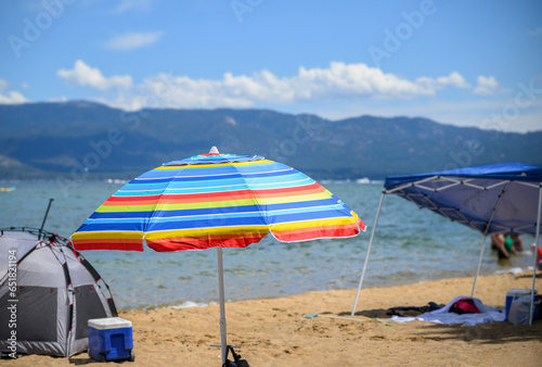 Beach umbrellas and tents at Pope Beach on a sunny summer day. South Lake Tahoe.