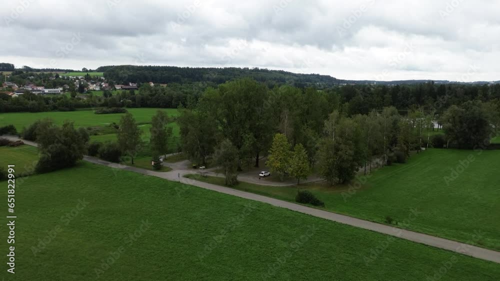 Beautiful flight on a drone, a quadrocopter above the green field and the village in Germany, Austria, Belgium. Ostvoi houses and tiled roofs. A small forest and roads on which cars drive. Beautiful flight on a drone, a quadrocopter above the green field and the village in Germany, Austria, Belgium. Ostvoi houses and tiled roofs. A small forest and roads on which cars drive.