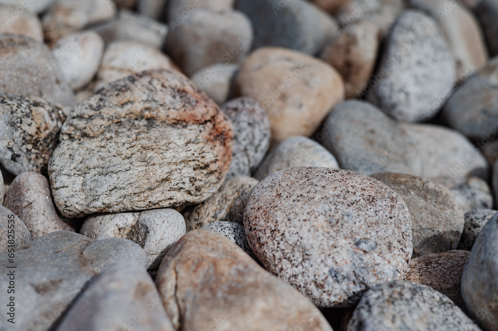 Abstract smooth round and sharp pebble nautical texture background. Stony shore of the sea or lake. Original stone texture. Close-up. Abstract smooth round and sharp pebble nautical texture background. Stony shore of the sea or lake. Original stone texture. Close-up.
