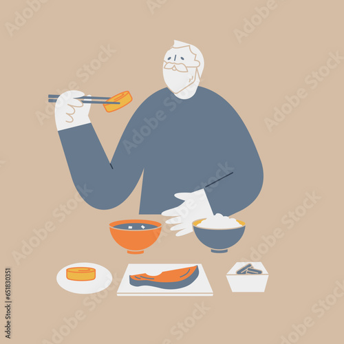 An elderly man eating Japanese food. He is smiling and eating Japanese omelet.