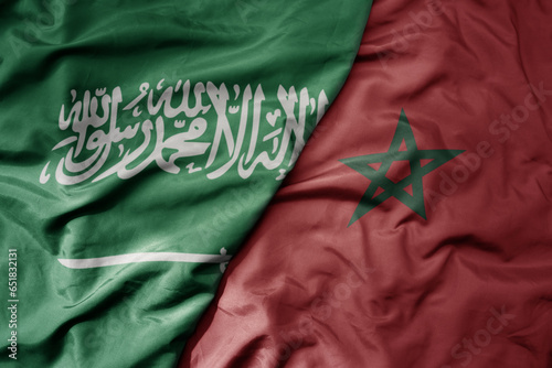 big waving realistic national colorful flag of saudi arabia and national flag of morocco .