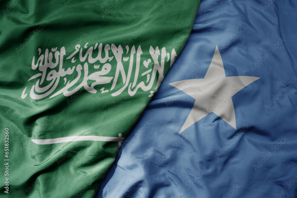 big waving realistic national colorful flag of saudi arabia and national flag of somalia .