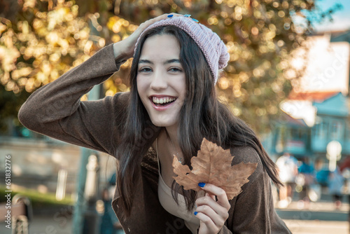portrait of beautiful smiling girl in autumn