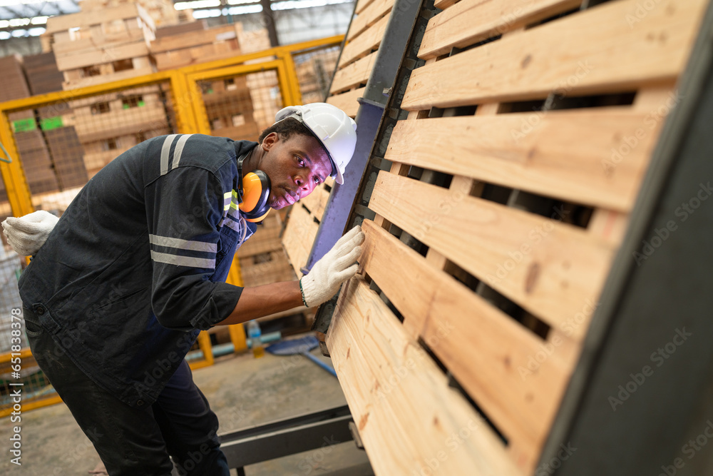 African American technician craft man checking timber at wood factory	