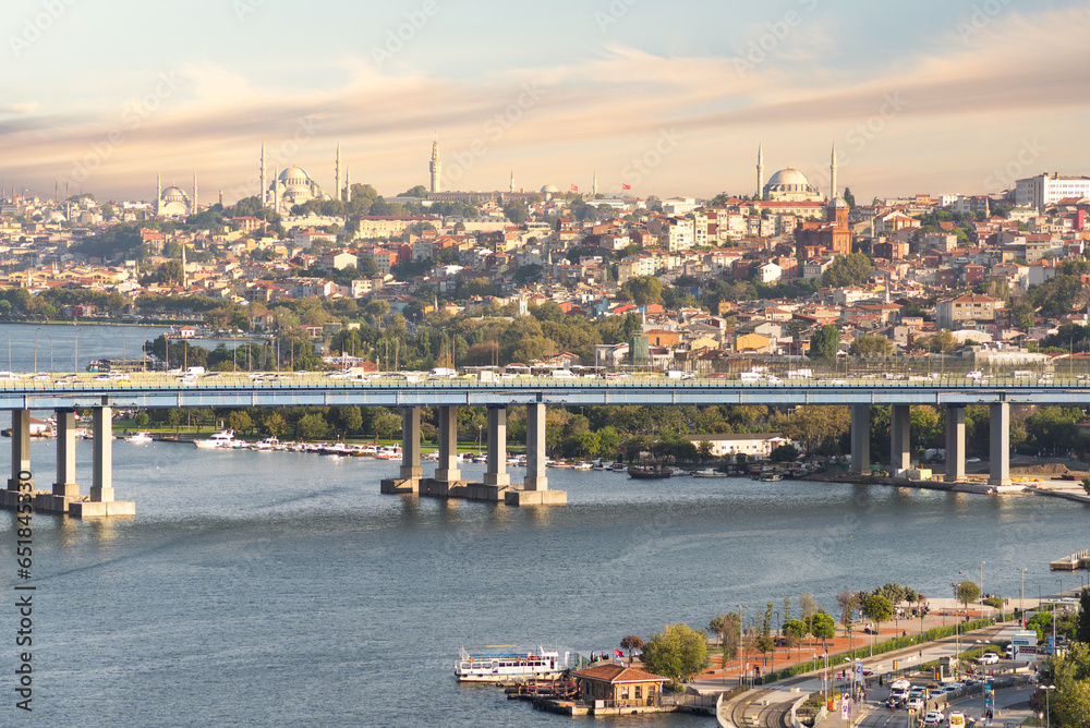 Aerial view from Pierre Loti popular hilltop park of the Halic Bridge, spanning the Golden Horn in Istanbul, Turkey, with background of city skyline, with historic mosques towering above the city