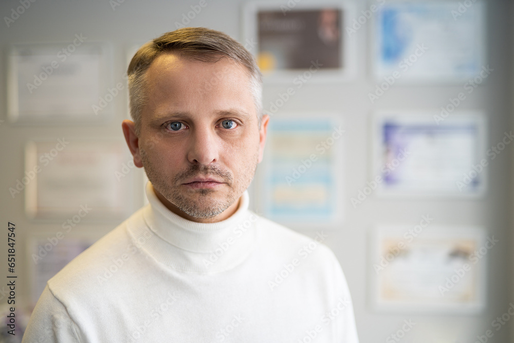 portrait of handsome adult man in a white sweater portrait of handsome adult man in a white sweater