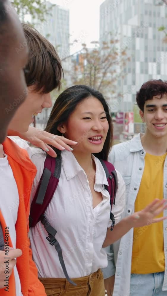 Group of happy young friends talking outside at college campus. Cheerful millennial students laughing and having fun together. Youth community and friendship concept. Vertical 9:16 screen video. Group of happy young friends talking outside at college campus. Cheerful millennial students laughing and having fun together. Youth community and friendship concept. Vertical 9:16 screen video.