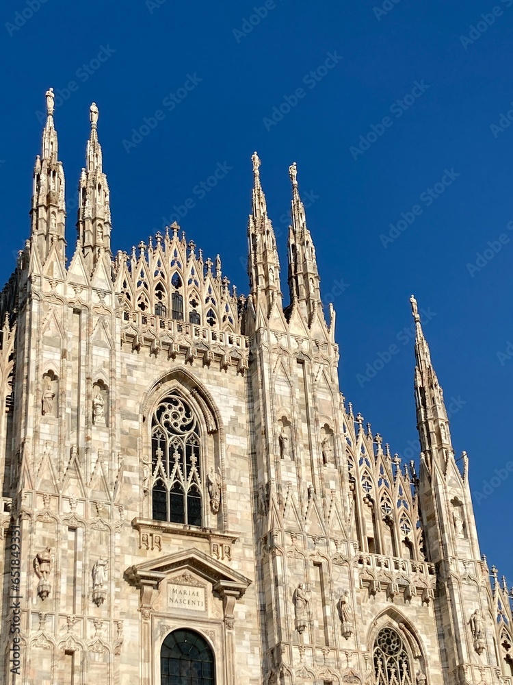 Colorful old buildings in Italy inside paintings and outside facades and rooftops views in the holiday summer, sunny blue sky day. Milan city center sightseeing big castle, tourists photographies.
