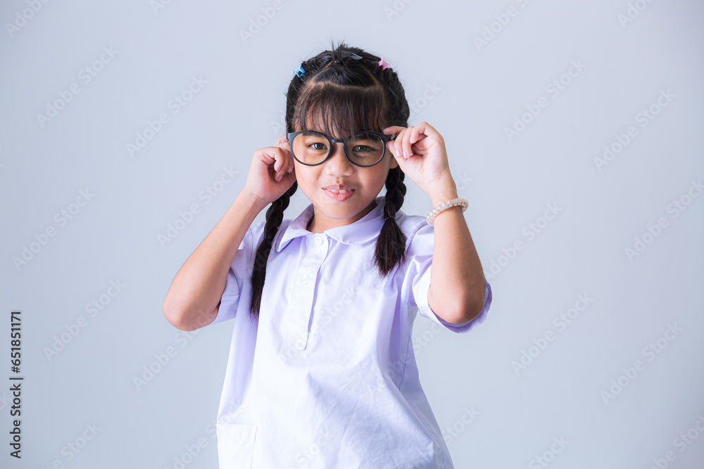 Girl in Thai school uniform,Portrait lovely Asian student girl in Thai school uniform pointing finger up isolated on pink background. Girl in Thai school uniform,Portrait lovely Asian student girl in Thai school uniform pointing finger up isolated on pink background.