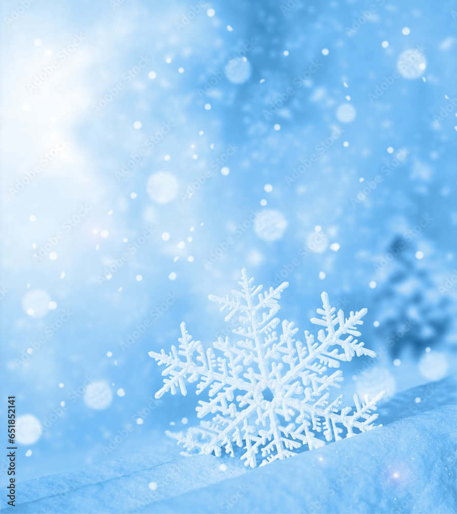 Snowflake shaped bokeh. Combined with blue background. Winter concept.