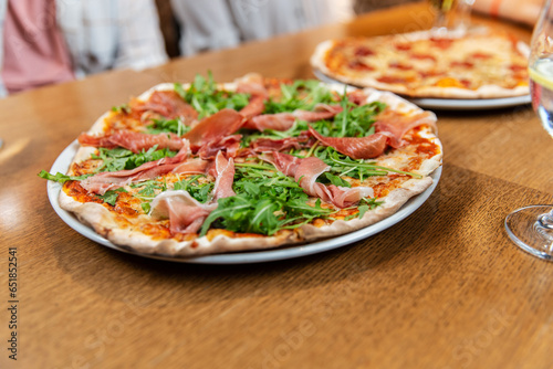fast food, italian kitchen and eating concept - close up of pizza on wooden table